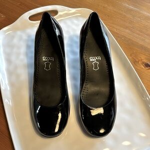 BCBG kitten heel, patent black leather with silver metal accents on heels.
